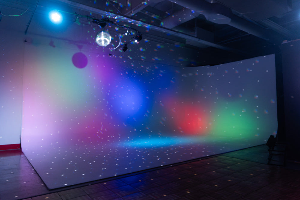 Cyclorama illuminated with multi-color stage lighting.