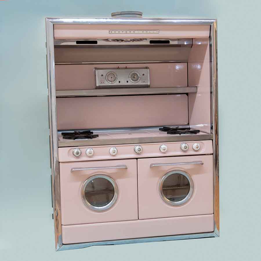 1950s pink stove range against a baby blue background.