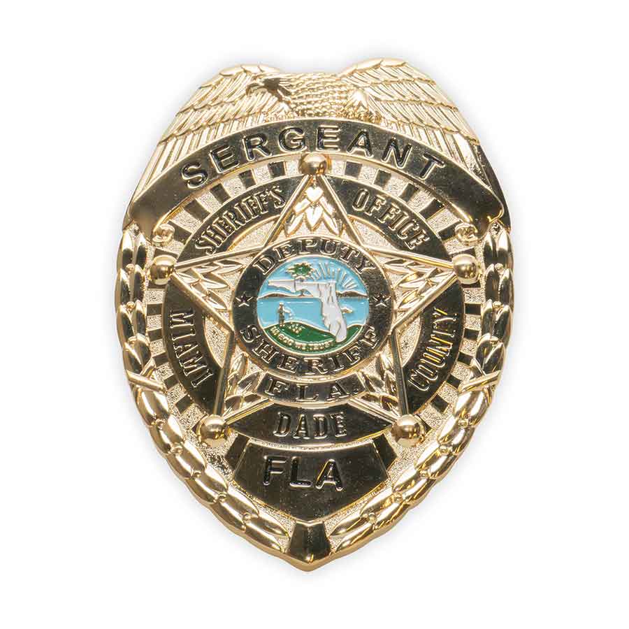 Gold police badge with 'Sergeant' and 'Sheriff's Office' text on a white background