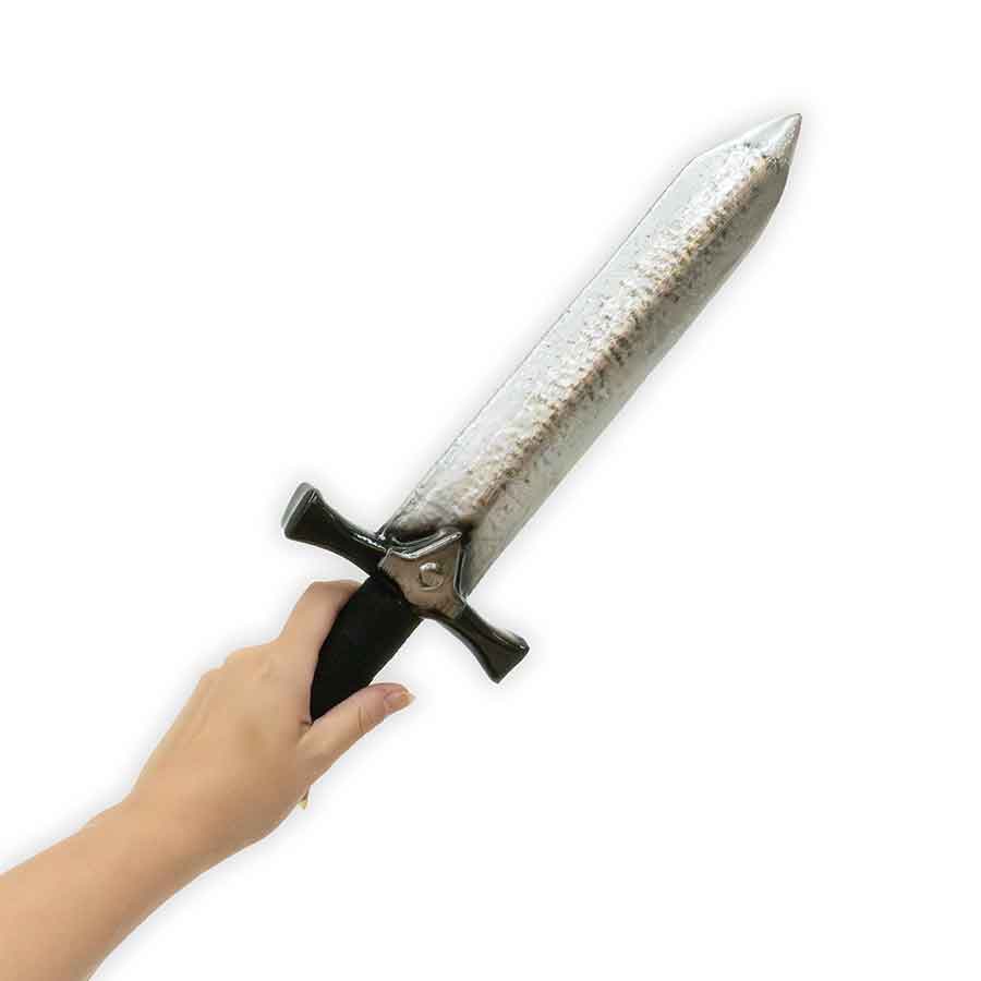 Hand holding a large dagger with a textured blade on a white background