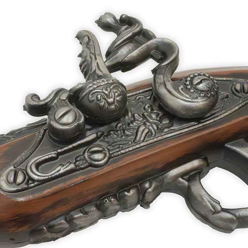 Close-up of a decorative firearm with intricate metalwork on a white background