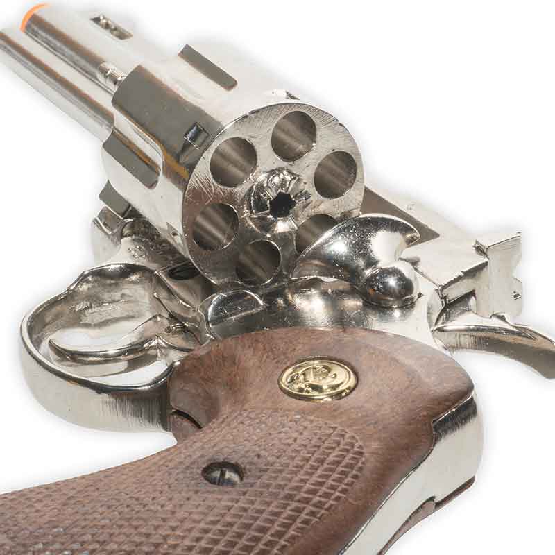 Close-up of a non-firing revolver with a wooden grip on a white background
