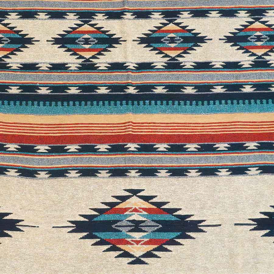 Close-up of a patterned fabric with geometric designs and horizontal stripes.