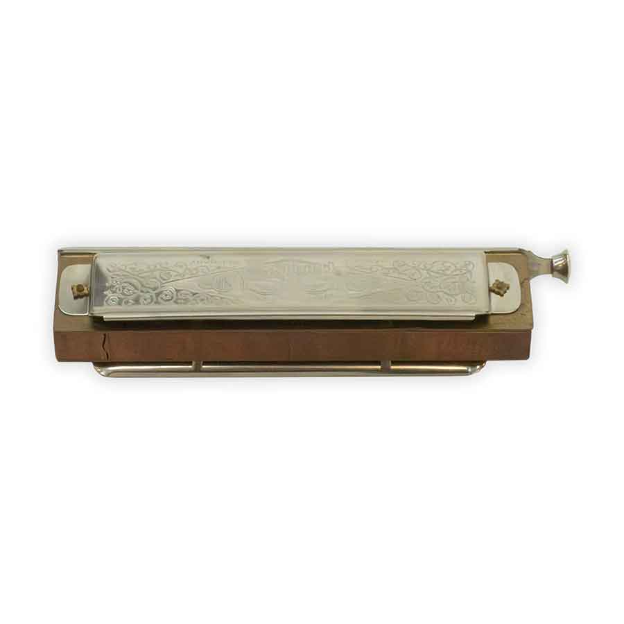 Wooden harmonica with metal mouthpiece on a white background