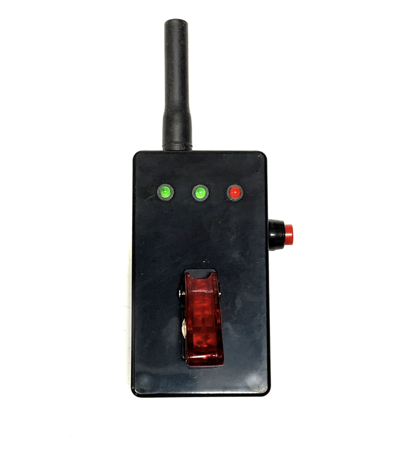 Detonator remote prop, black plastic prop has an antenna, 3 led lights (2 green and 1 red) a red switch cover and metal switch as well as red button on the side of remote.